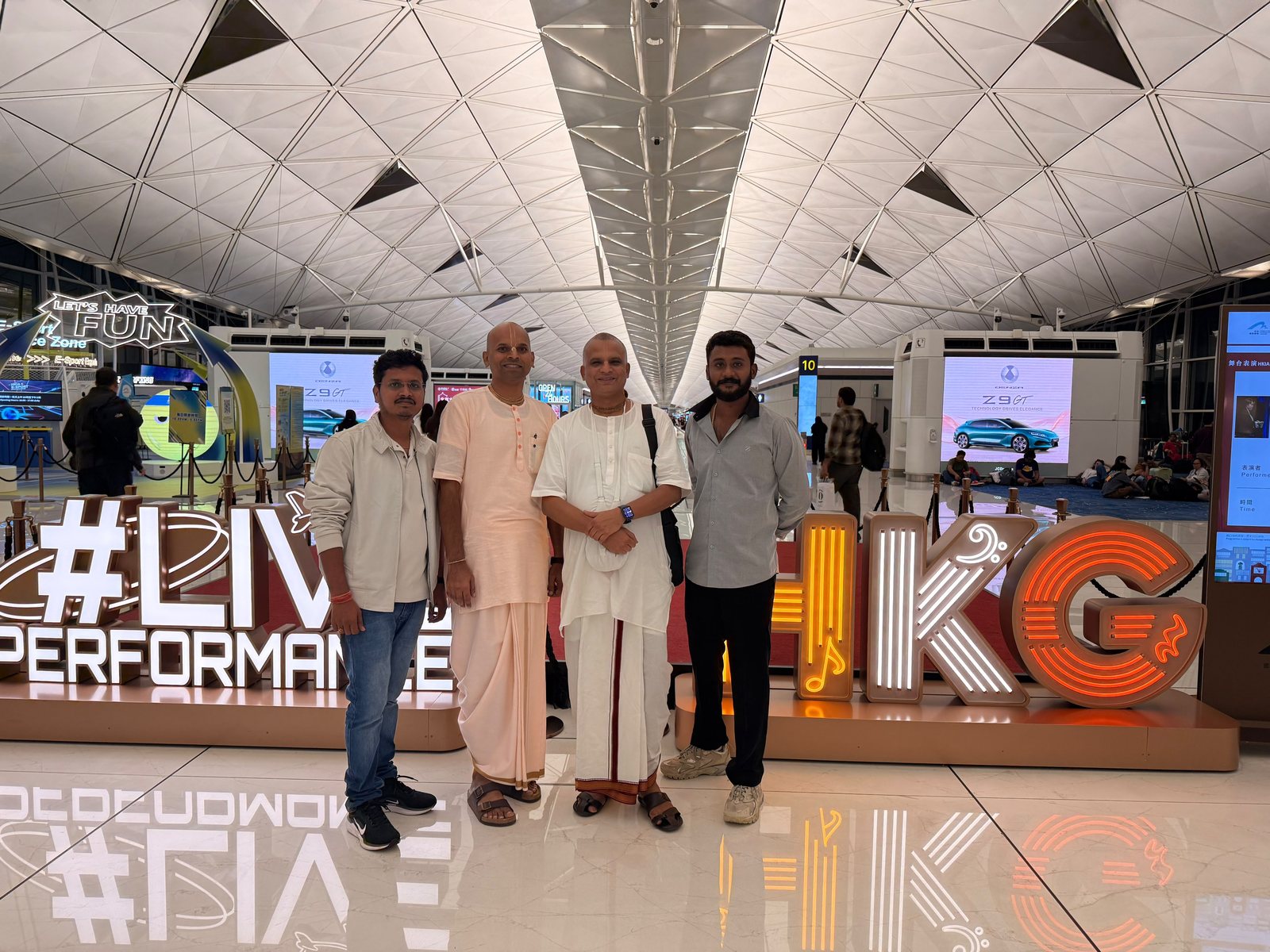 Bollam Rishithej with Yagneshwara Dasa, Bharatarshabha Dasa and companions at Hong Kong International Airport